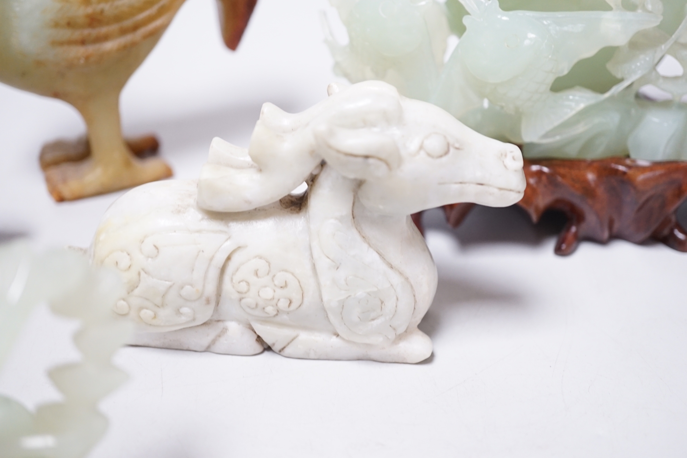 A group of four Chinese bowenite jade and hardstone carvings, the ‘sea creatures’ vase and cover, 18 cm high excluding wood stand